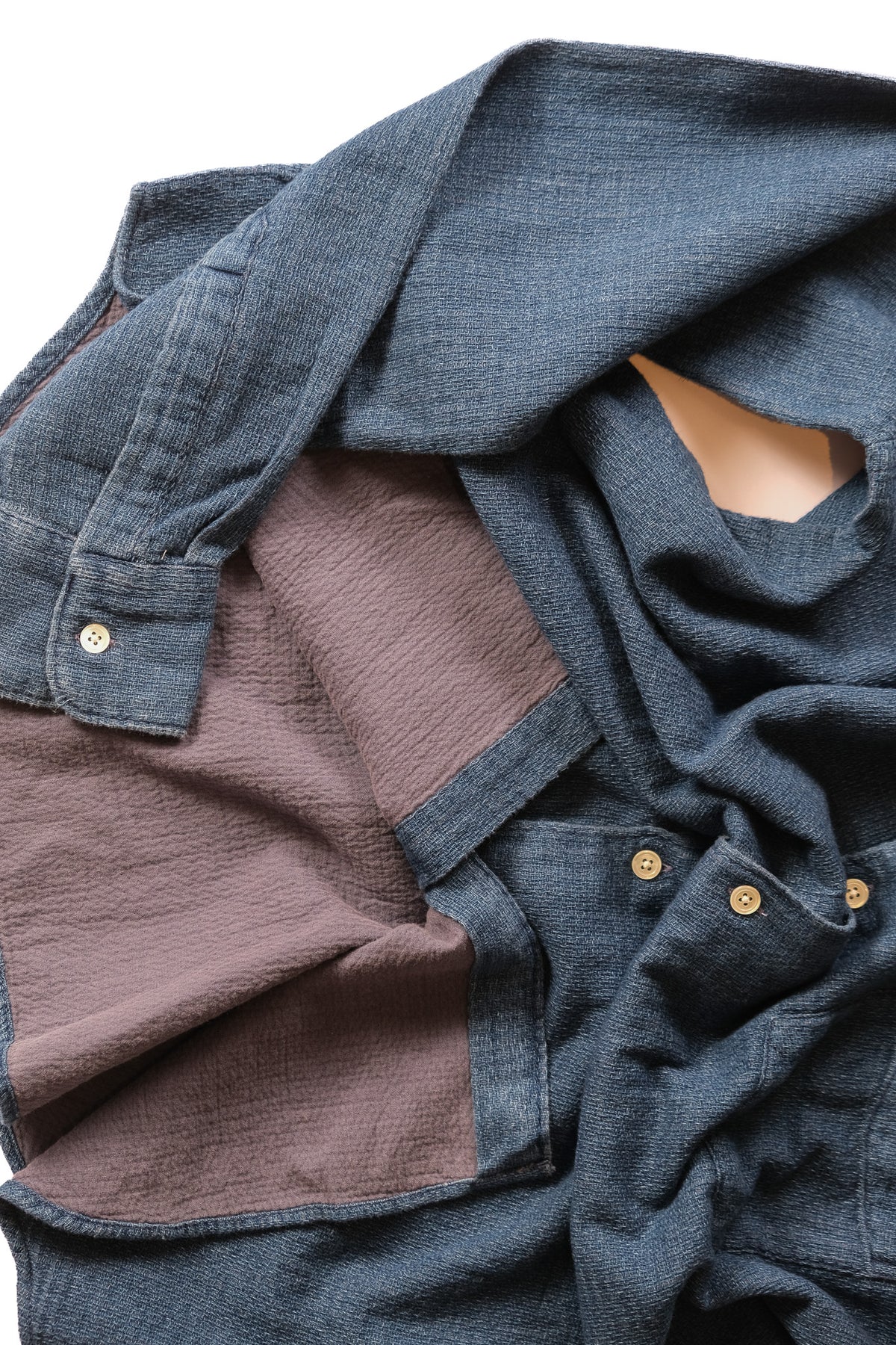 A close-up of a blue textured button up