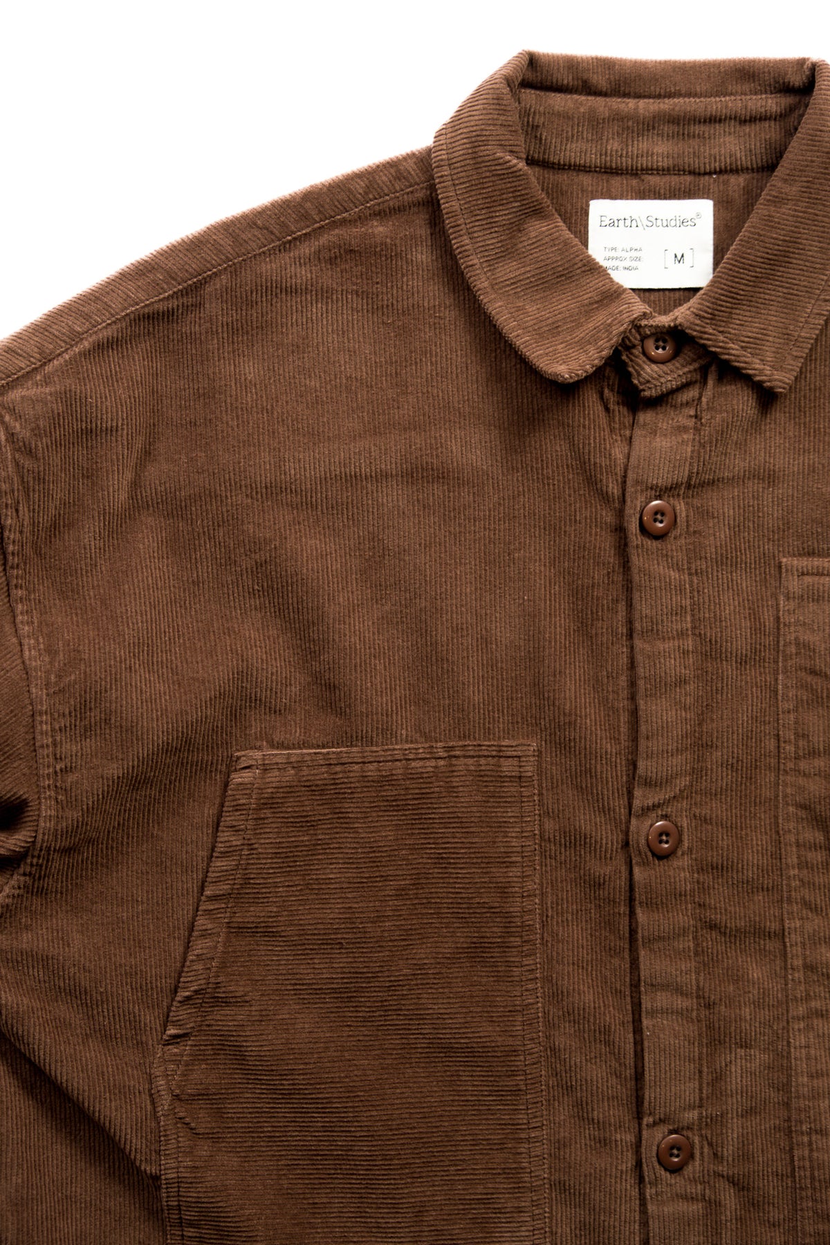 A close-up of a brown corduroy button-up shirt with a pointed collar and a chest pocket, shown against a plain white background.