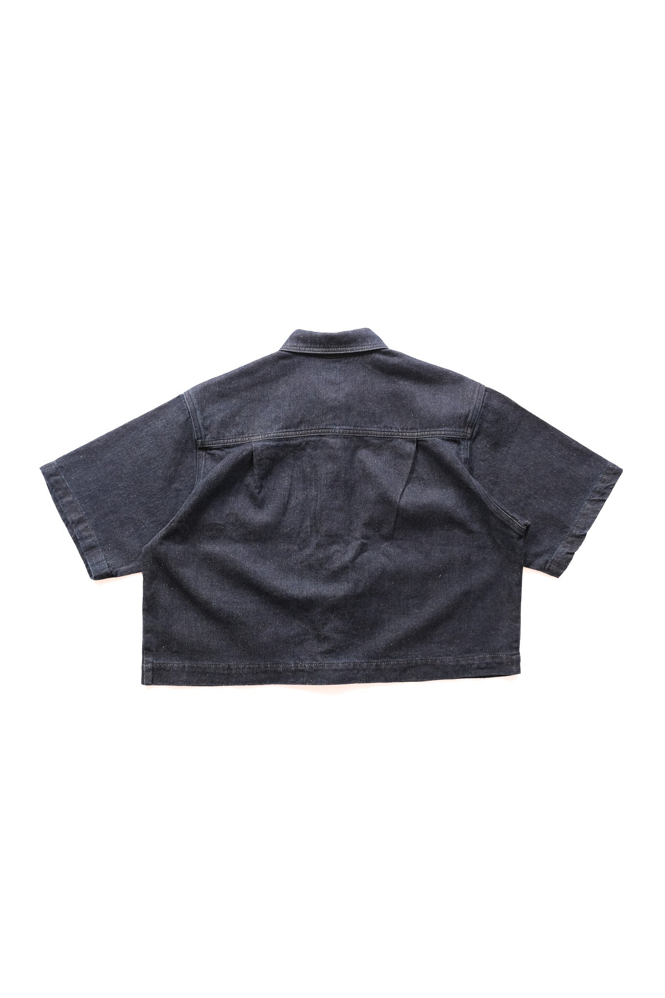 A dark denim short-sleeve button-up shirt shown from the back, laid flat against a solid white background.