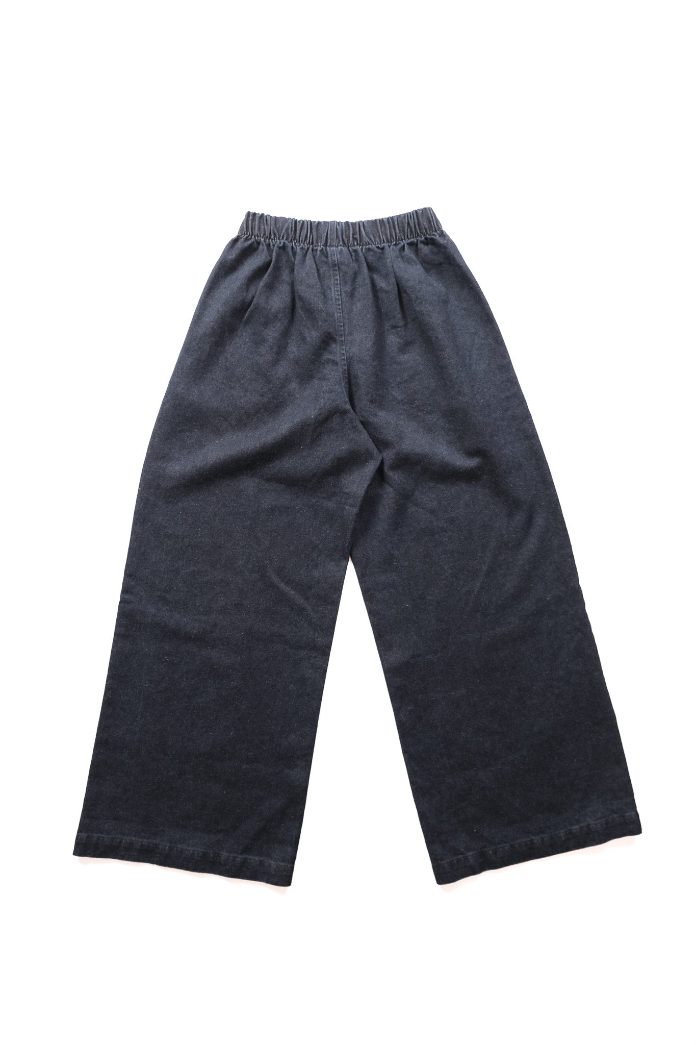Dark indigo wide-leg denim pants with an elastic waistband, laid flat on a white background.