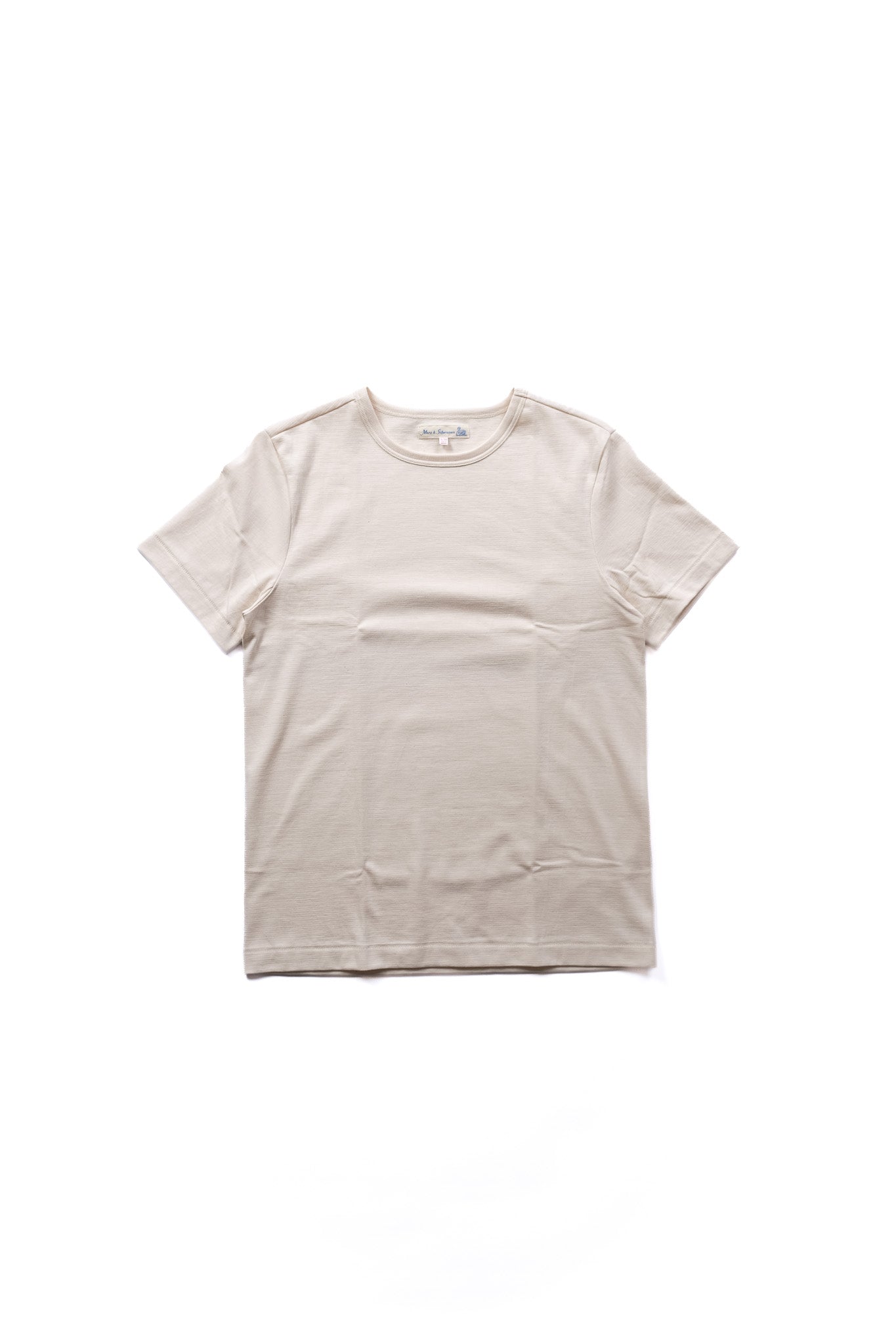 A light beige crewneck short-sleeve t-shirt laid flat against a solid white background.