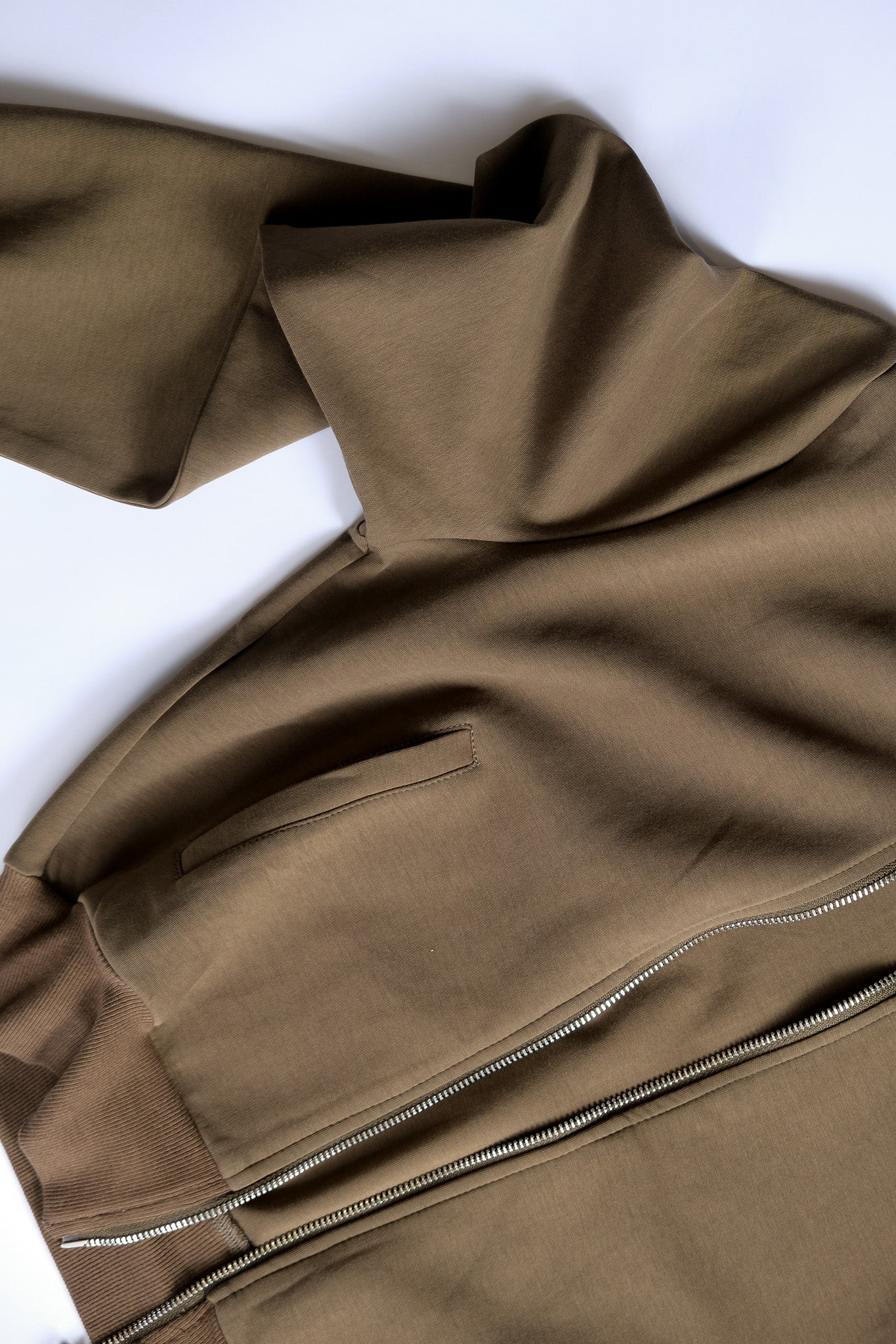 close up of track jacket showing front pockets and zipper