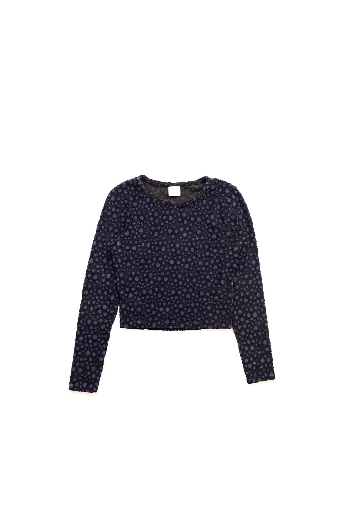 A long-sleeve cropped top with an all-over small blue polk a dot pattern, displayed flat against a solid white background.
