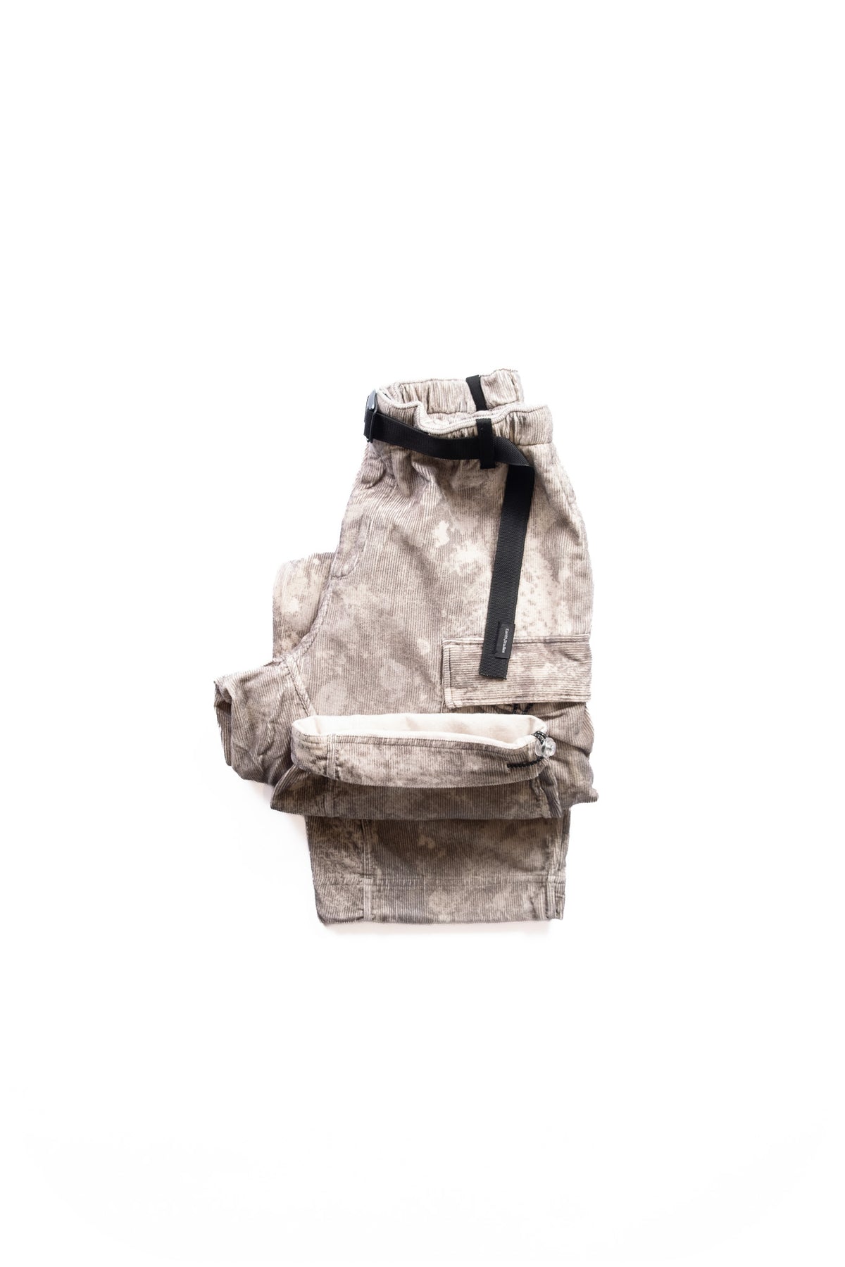 A pair of faded beige cargo pants folded with a black belt, laid flat on a solid white background.