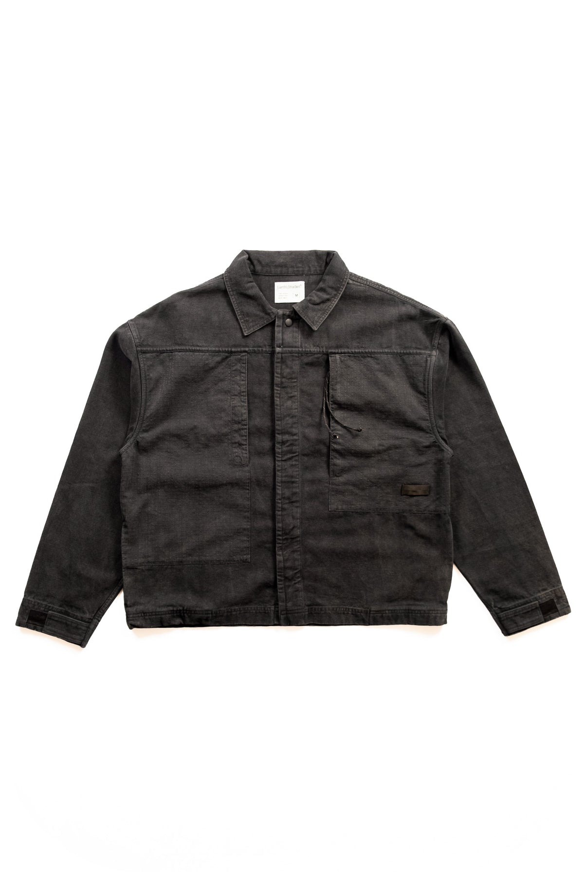 A dark charcoal gray cotton utility jacket with a button-up front, collar, and chest pockets, laid flat against a white background.