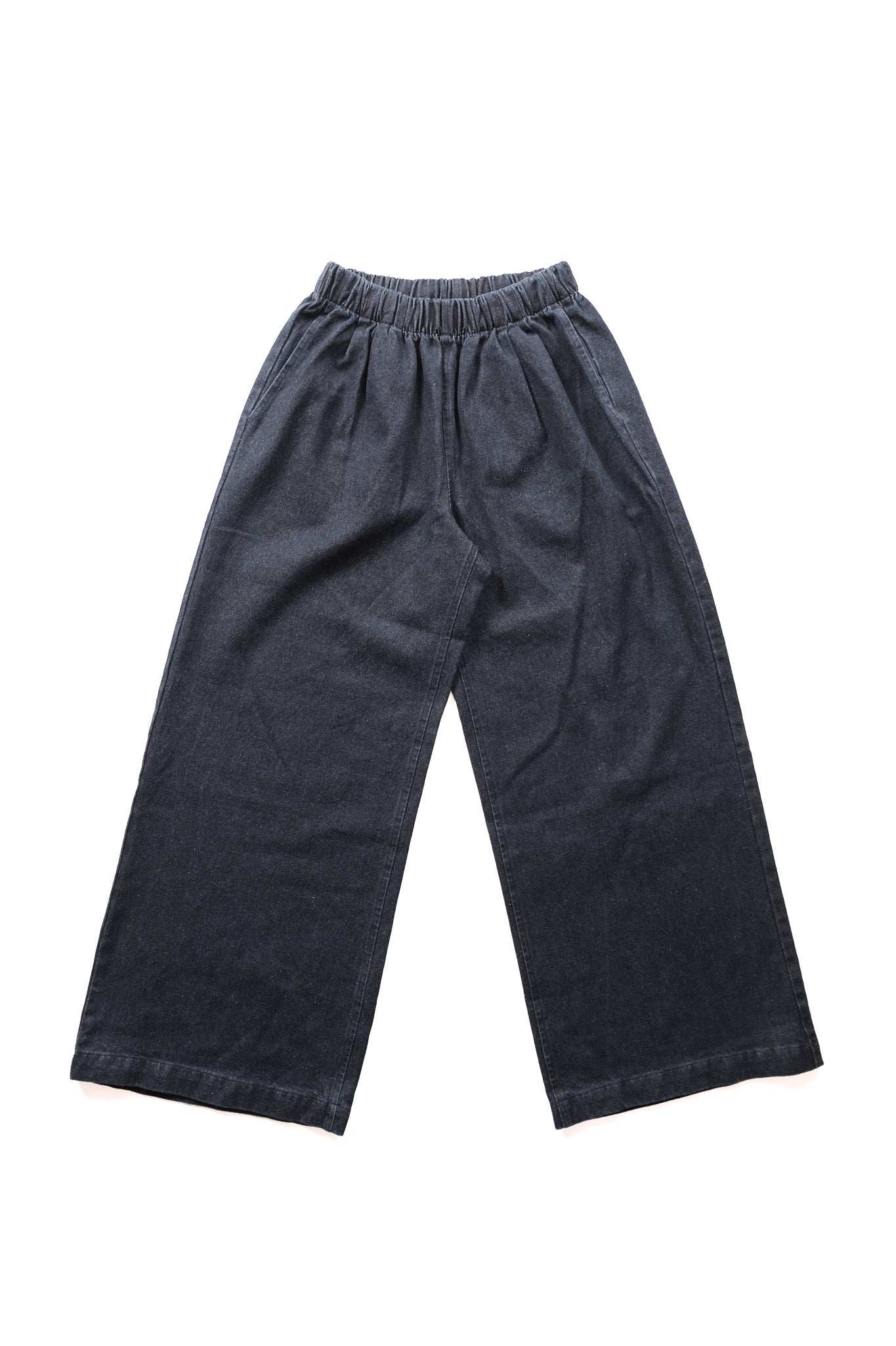 Dark indigo wide-leg denim pants with an elastic waistband, laid flat on a white background.