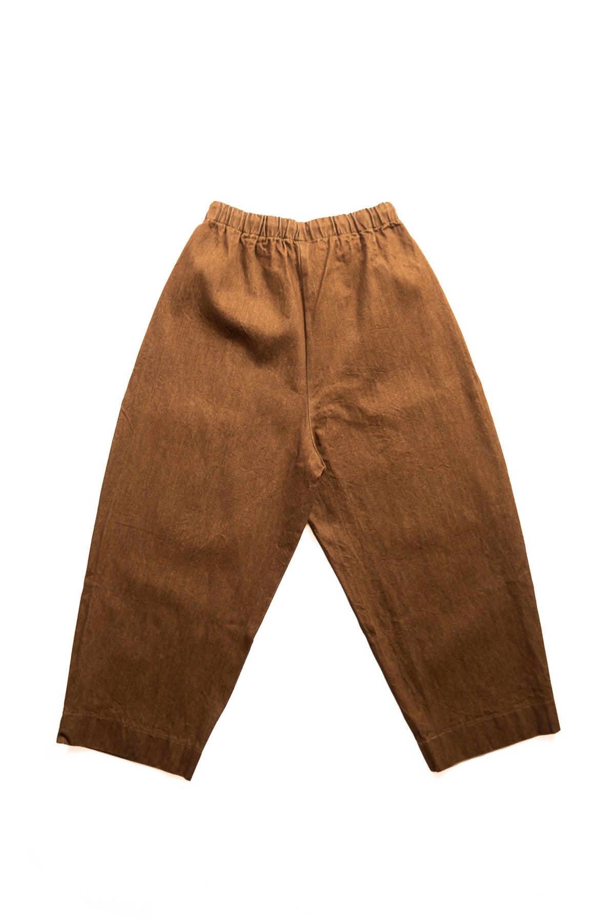 A pair of loose-fitting brown pants with an elastic waistband, laid flat against a solid white background.
