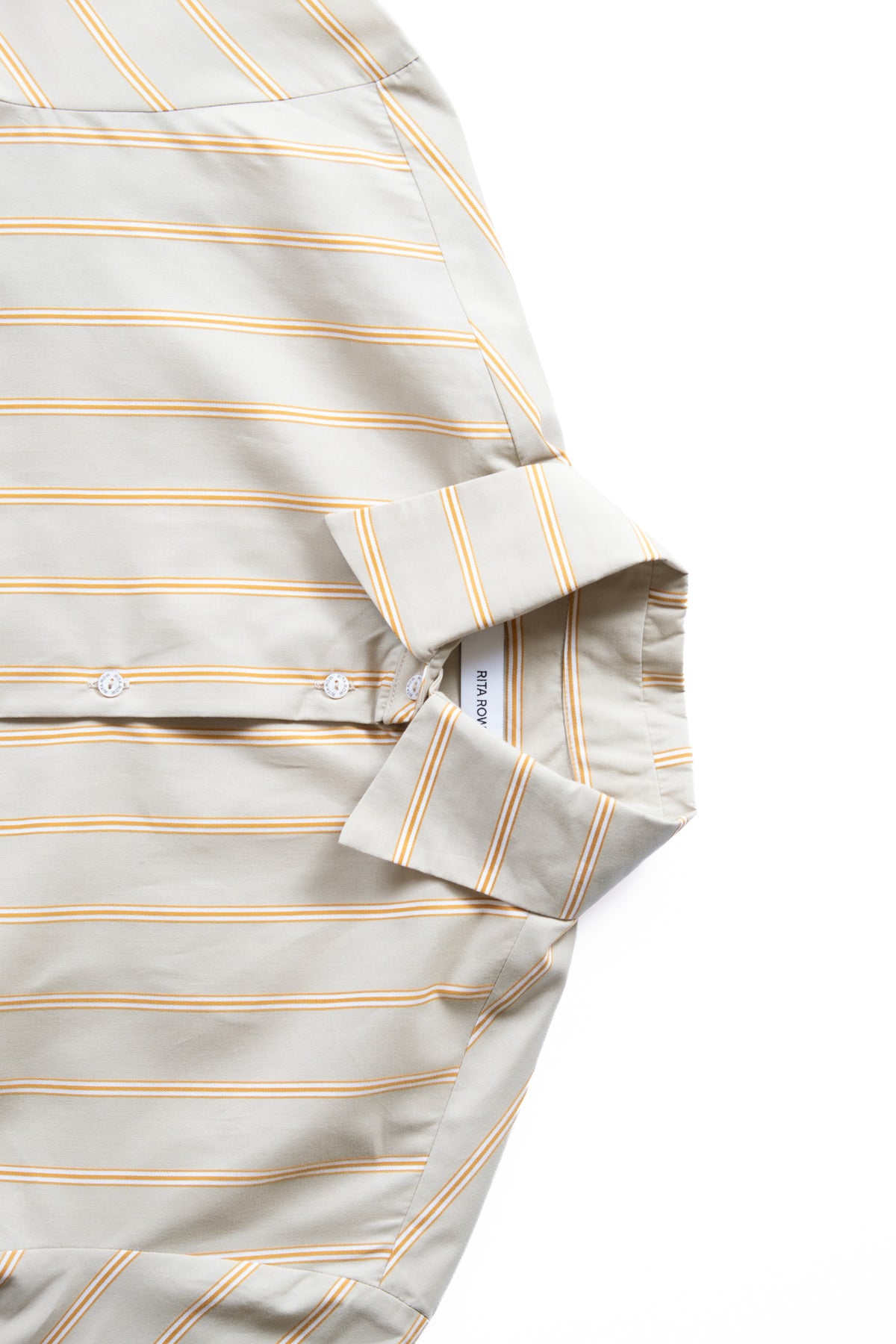 Close-up of a light green shirt with thin tan and white vertical stripes, featuring a pointed collar. 