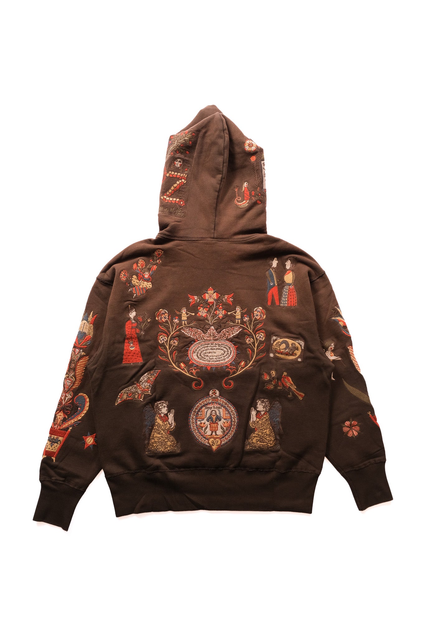 A dark brown hooded sweatshirt shown from the back, featuring embroidered motifs inspired by american folk with various characters, symbols, and decorative motifs in red, gold, and beige tones.